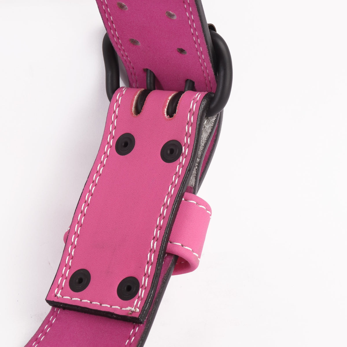 Pink weightlifting belt with black eyelets and white stitching.